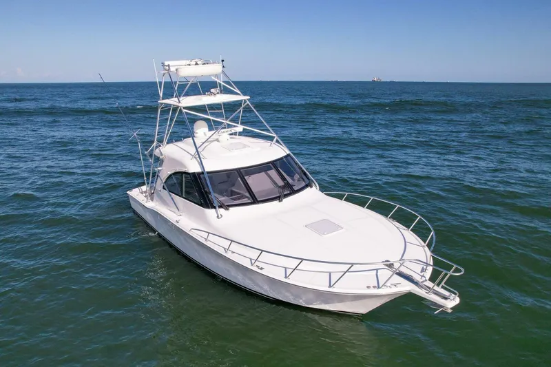 Slide: The Image of 2012 Cabo 40 Hardtop Express yacht cruising on open sea. - 54