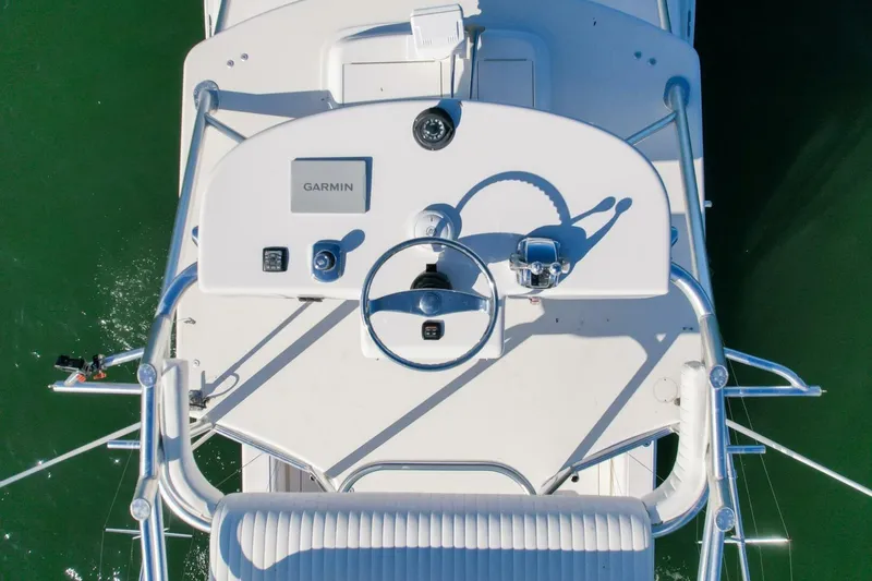 Slide: The Image of Overhead view of 2012 Cabo 40 Hardtop Express boat helm with Garmin equipment. - 55