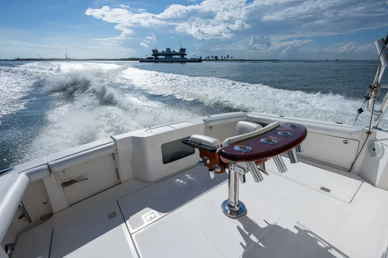Slide: The Image of 2012 Cabo 40 Hardtop Express cruising on open water, leaving a wake behind. - 7