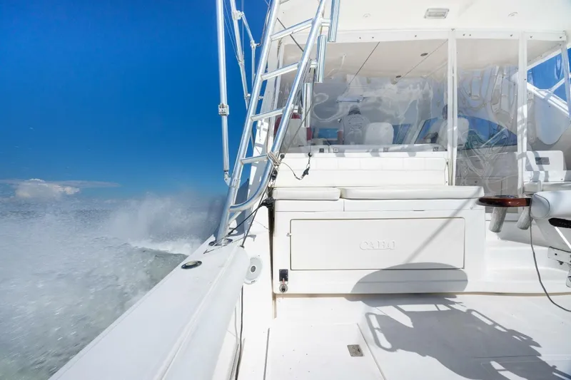 Slide: The Image of 2012 Cabo 40 Hardtop Express cruising on open water under clear blue skies. - 9