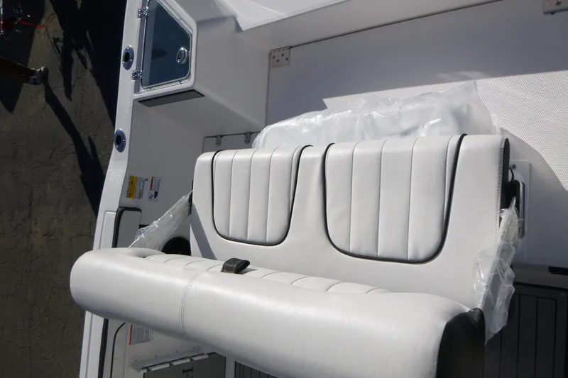 Slide: The Image of 2026 Yamaha Boats 222 FSH Sport E interior seating, featuring white cushioned seats. - 16