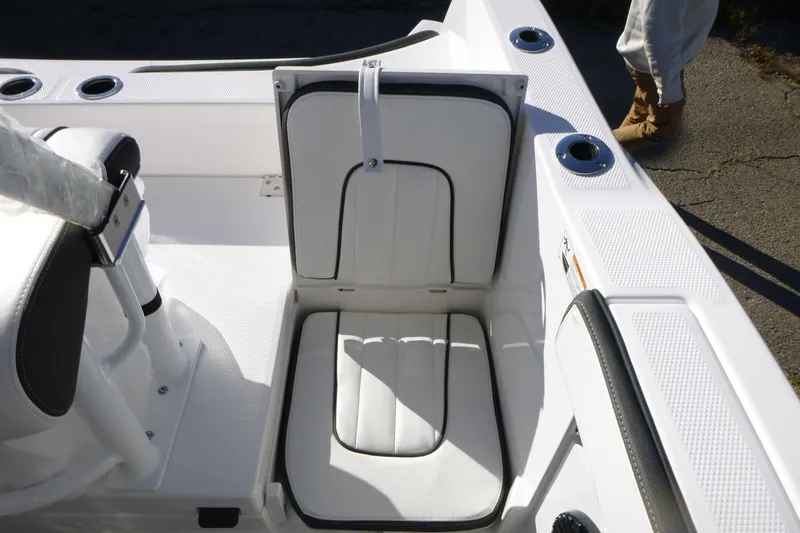 Slide: The Image of 2026 Yamaha Boats 222 FSH Sport E interior seating with storage compartment. - 17