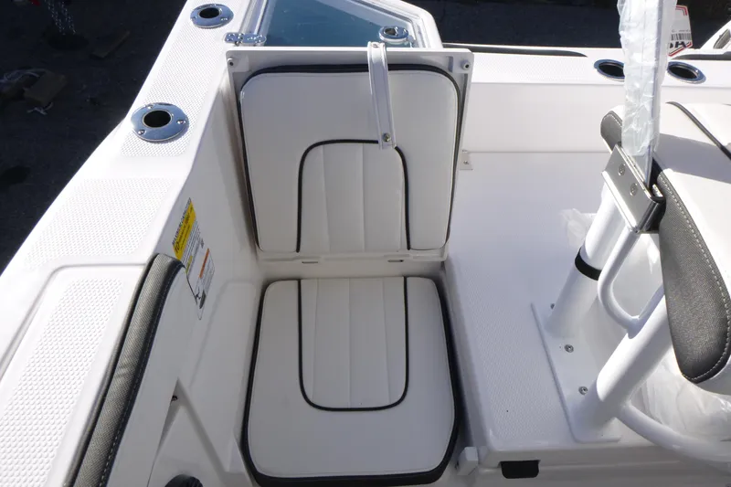 Slide: The Image of 2026 Yamaha Boats 222 FSH Sport E interior seating detail, featuring white cushioned seats. - 18