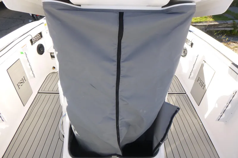 Slide: The Image of 2026 Yamaha Boats 222 FSH Sport E interior with protective cover and deck details. - 8