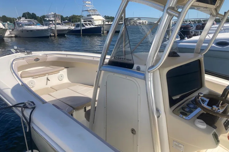 Slide: The Image of 2007 Scout 262 Sportfish boat docked at marina, featuring spacious seating and control console. - 4