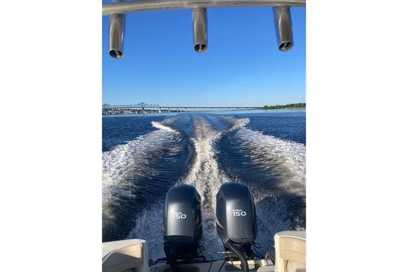 Slide: The Image of 2007 Scout 262 Sportfish boat cruising with twin Yamaha 150 engines, leaving a wake. - 7