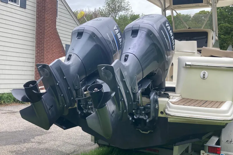 Slide: The Image of 2007 Scout 262 Sportfish with dual Yamaha outboard motors, parked near a house. - 8