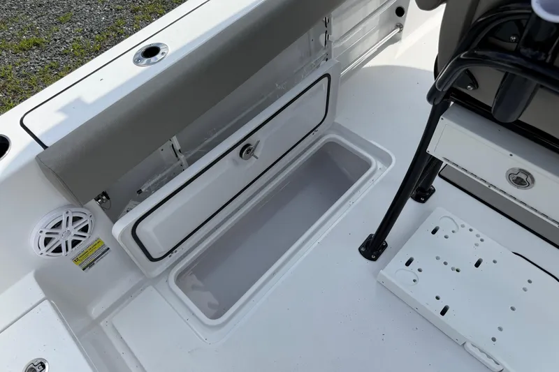 Slide: The Image of 2026 Sportsman Open 252 Center Console boat interior with storage compartment open. - 12