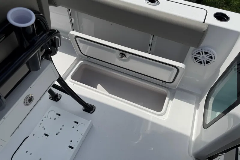 Slide: The Image of 2026 Sportsman Open 252 Center Console boat interior with storage compartment and speaker. - 13