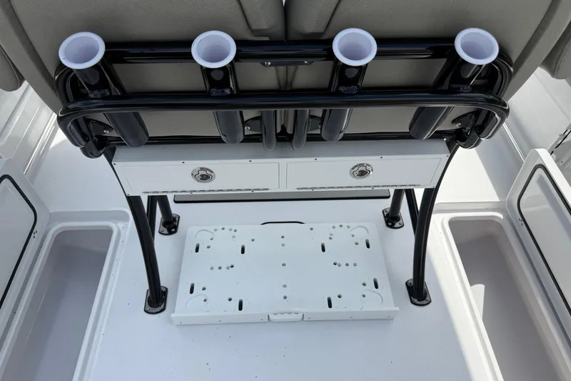 Slide: The Image of 2026 Sportsman Open 252 Center Console boat interior with rod holders and storage compartments. - 14