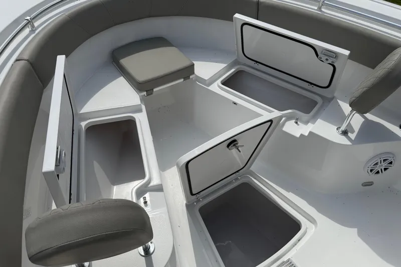 Slide: The Image of 2026 Sportsman Open 252 Center Console boat interior with open storage compartments and seating. - 24
