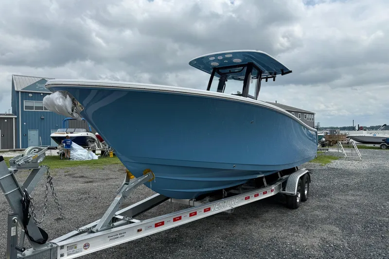 Slide: The Image of 2026 Sportsman Open 252 Center Console boat on trailer, displayed outdoors. - 4