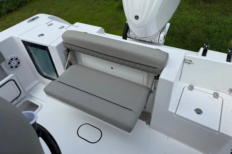 Slide: The Image of 2026 Sportsman Open 252 Center Console boat with cushioned seating and storage compartments. - 9