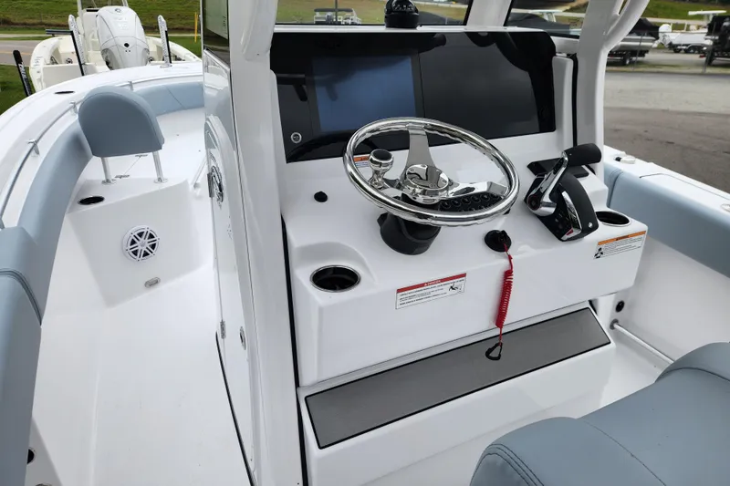 Slide: The Image of 2026 Sportsman Heritage 231 Center Console boat interior with steering wheel and controls. - 15