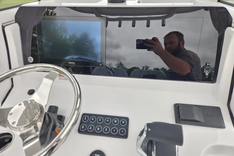 Slide: The Image of 2026 Sportsman Heritage 231 Center Console dashboard with steering wheel and control panel. - 16