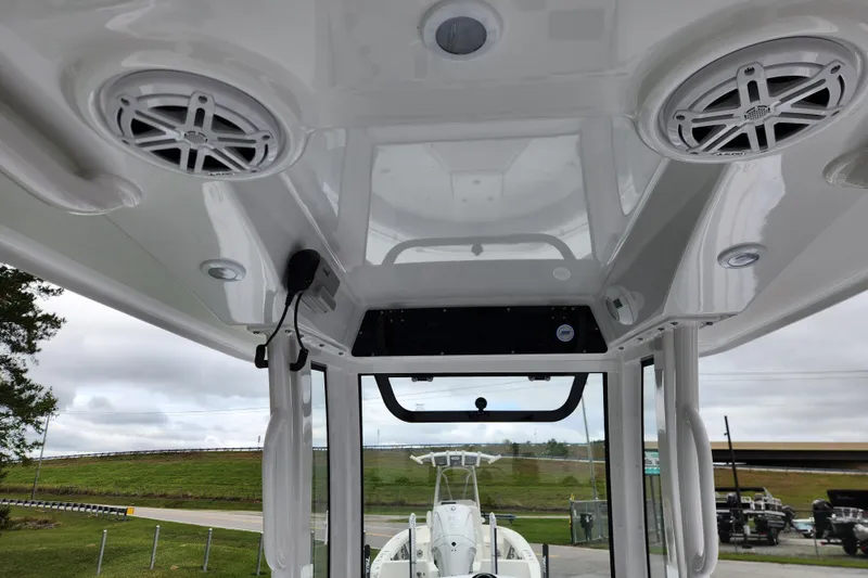 Slide: The Image of 2026 Sportsman Heritage 231 Center Console boat interior with speakers and console view. - 17