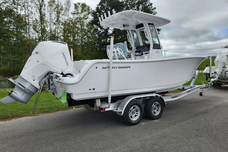Slide: The Image of 2026 Sportsman Heritage 231 Center Console boat on trailer, parked outdoors. - 2