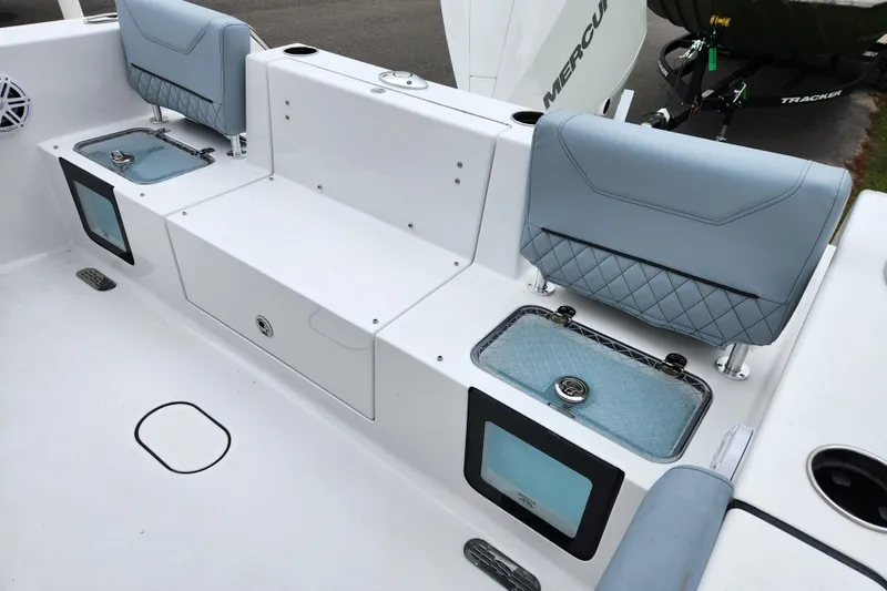 Slide: The Image of 2026 Sportsman Heritage 231 Center Console boat interior with cushioned seating and storage compartments. - 20