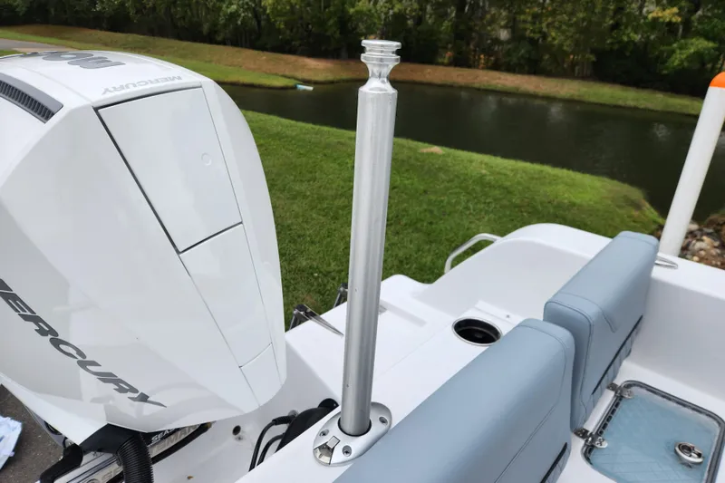 Slide: The Image of 2026 Sportsman Heritage 231 Center Console boat with Mercury engine by a lake. - 22