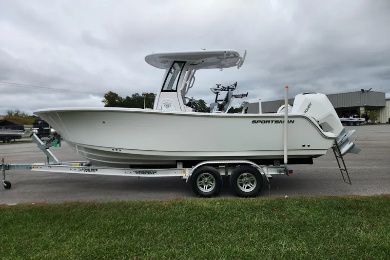 Slide: The Image of 2026 Sportsman Heritage 231 Center Console boat on trailer, parked outdoors. - 5