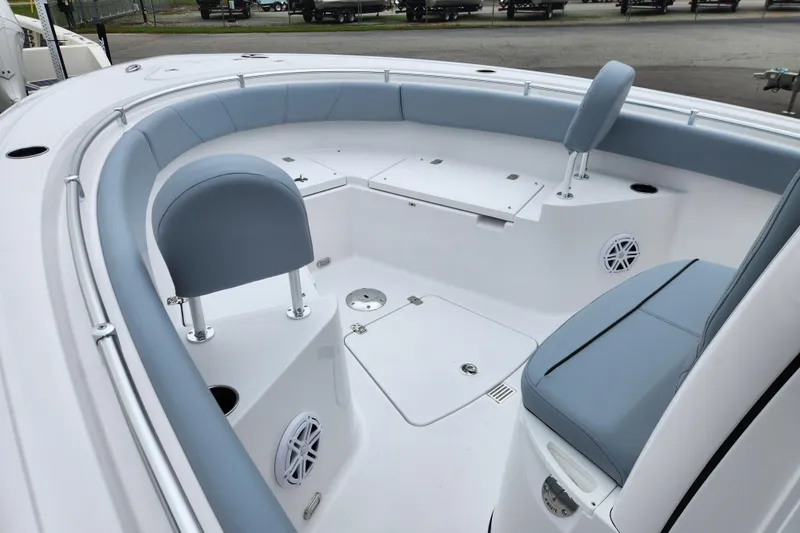 Slide: The Image of 2026 Sportsman Heritage 231 Center Console boat interior with blue seating and storage compartments. - 8