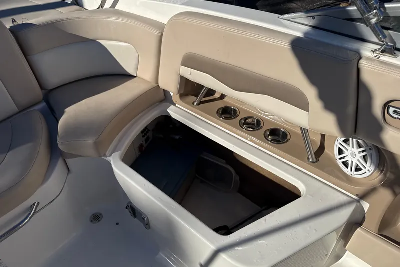 Slide: The Image of 2012 Chaparral 246 SSi boat interior with open storage compartment and cup holders. - 10