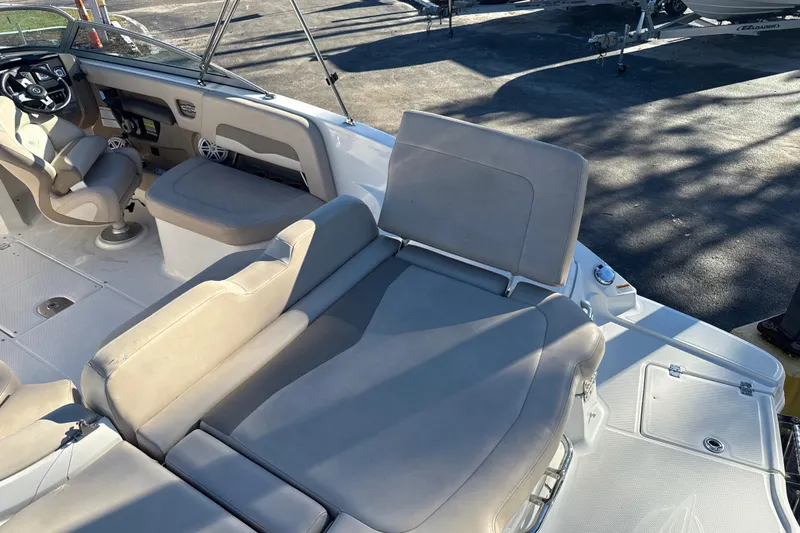 Slide: The Image of 2012 Chaparral 246 SSi boat interior with beige seating and steering console. - 14