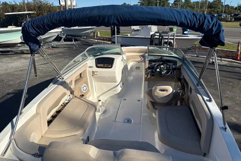 Slide: The Image of 2012 Chaparral 246 SSi boat interior with seating, steering wheel, and blue canopy. - 15