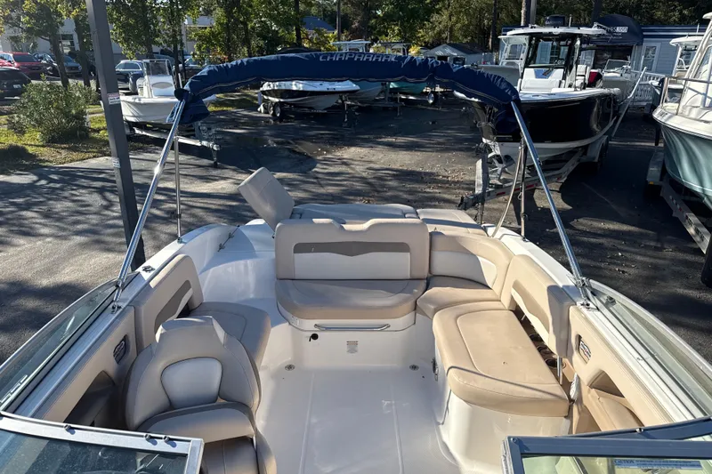 Slide: The Image of 2012 Chaparral 246 SSi boat interior with beige seating and blue canopy. - 16