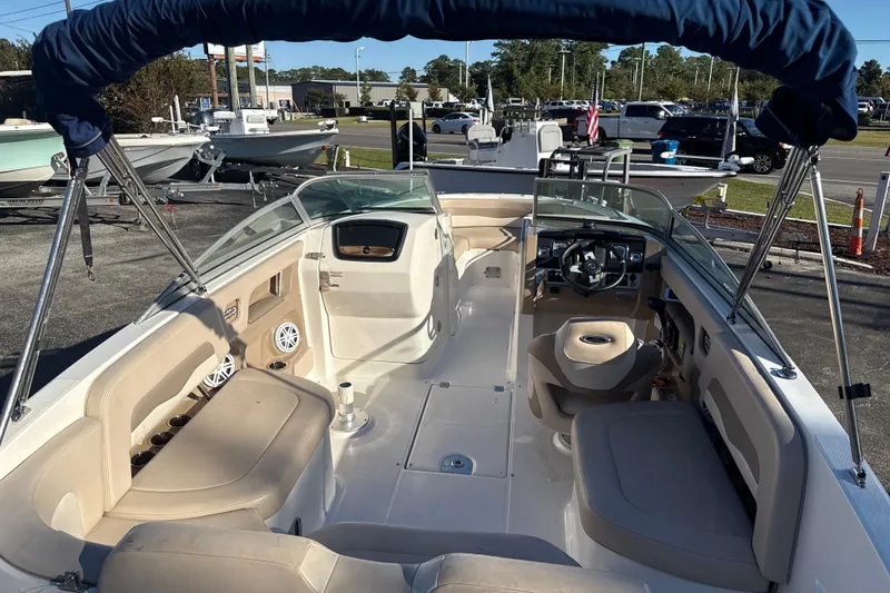 Slide: The Image of 2012 Chaparral 246 SSi boat interior with seating, steering wheel, and canopy. - 4