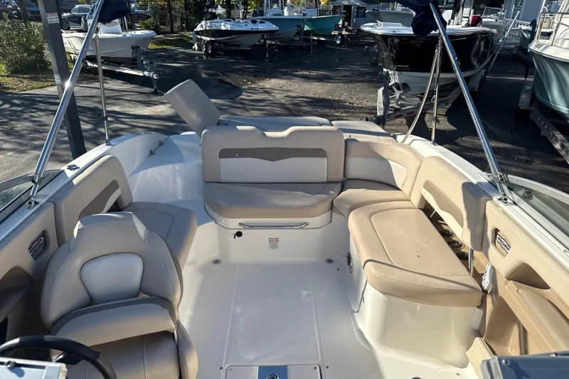 Slide: The Image of 2012 Chaparral 246 SSi boat interior with beige seating and spacious layout. - 7