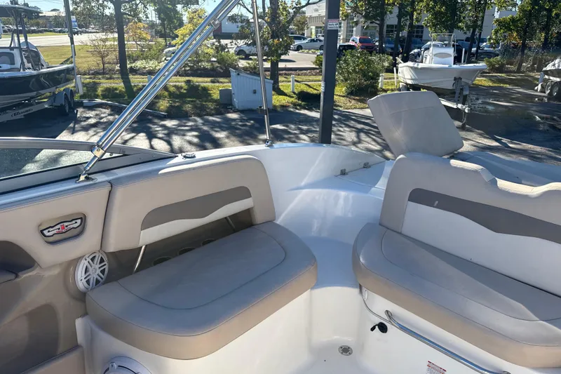 Slide: The Image of 2012 Chaparral 246 SSi boat interior with beige seating and chrome accents. - 9