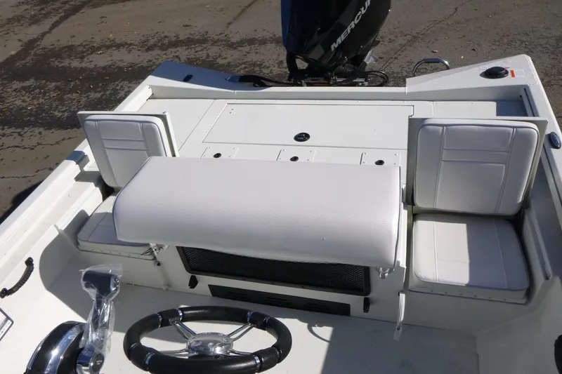 Slide: The Image of 2025 Ranger RB210 boat interior with white seating and steering wheel. - 15