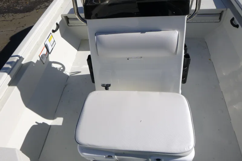 Slide: The Image of 2025 Ranger RB210 boat interior with white cushioned seating and steering console. - 9