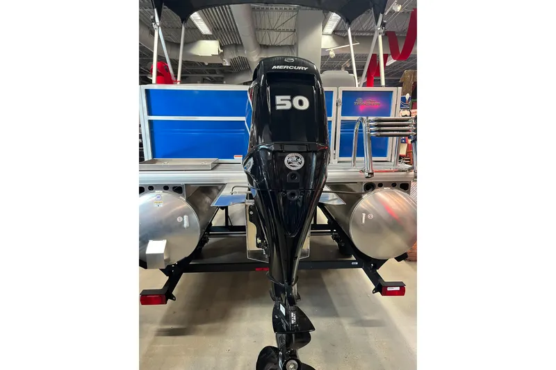 Slide: The Image of 2026 Sun Tracker Party Barge 16 DLX with Mercury 50 outboard motor in showroom. - 5