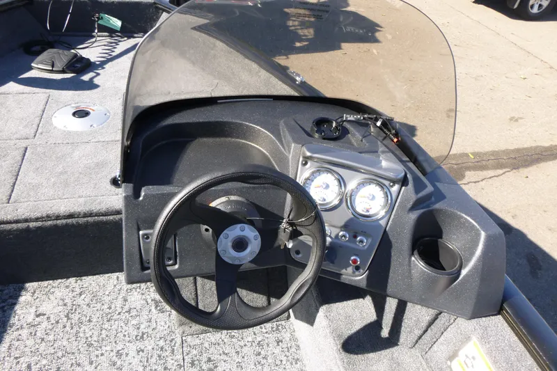 Slide: The Image of 2026 Tracker Pro Guide V-16 SC boat dashboard with steering wheel and gauges. - 10