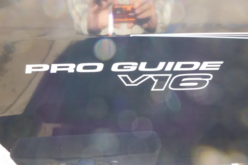 Slide: The Image of 2026 Tracker Pro Guide V-16 SC boat logo with reflective surface. - 14