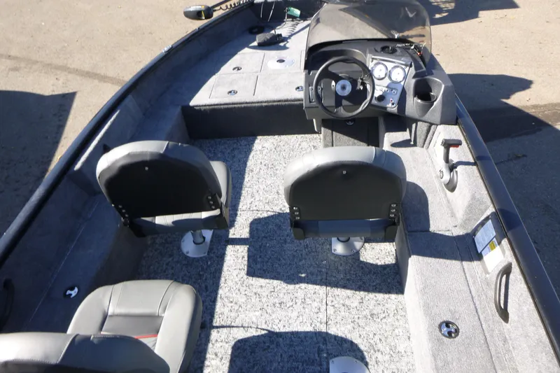 Slide: The Image of 2026 Tracker Pro Guide V-16 SC boat interior with steering console and seating. - 4