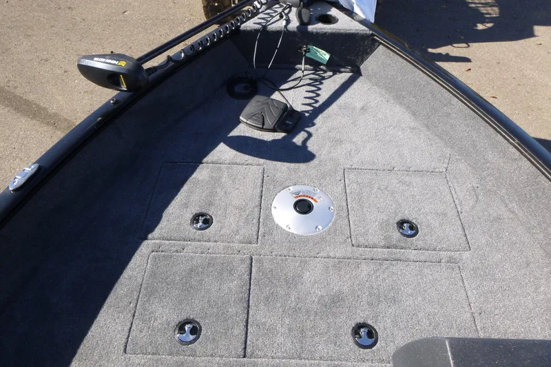 Slide: The Image of 2026 Tracker Pro Guide V-16 SC boat deck with storage compartments and trolling motor. - 6