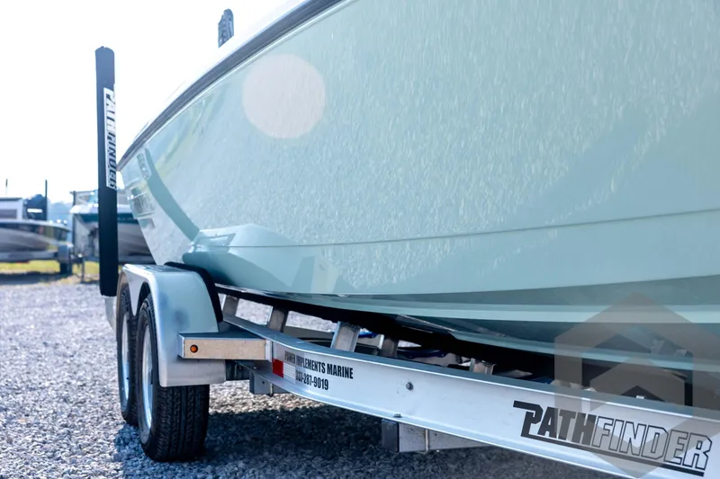 Slide: The Image of 2026 Pathfinder 2200 TRS boat on trailer, side view, outdoors. - 12