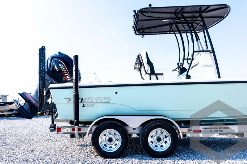 Slide: The Image of 2026 Pathfinder 2200 TRS boat on trailer with Yamaha engine, side view. - 13