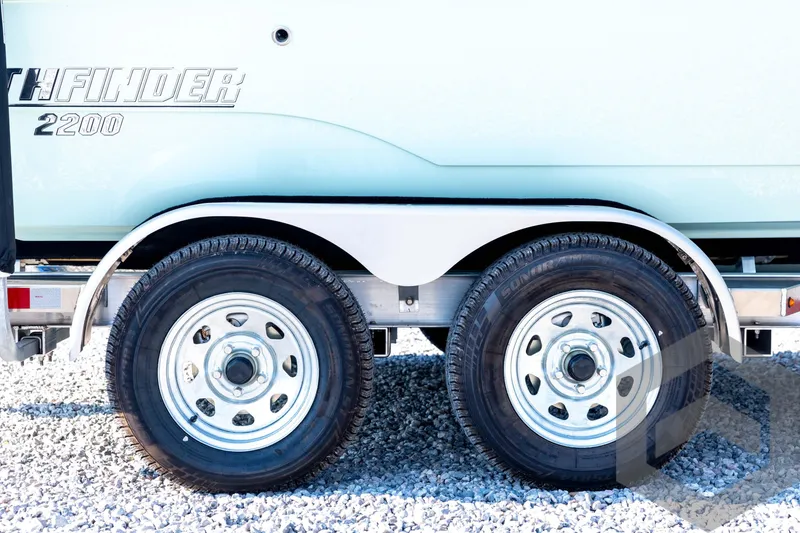 Slide: The Image of 2026 Pathfinder 2200 TRS trailer with dual wheels on gravel surface. - 14