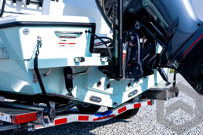 Slide: The Image of 2026 Pathfinder 2200 TRS boat on trailer, showcasing engine and rear details. - 21