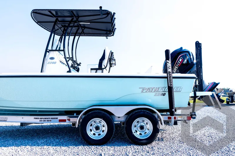 Slide: The Image of 2026 Pathfinder 2200 TRS boat on trailer, side view, with outboard motor. - 30
