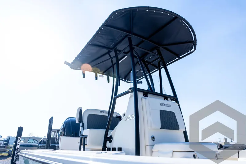 Slide: The Image of 2026 Pathfinder 2200 TRS boat with T-top, viewed from below against a clear sky. - 34