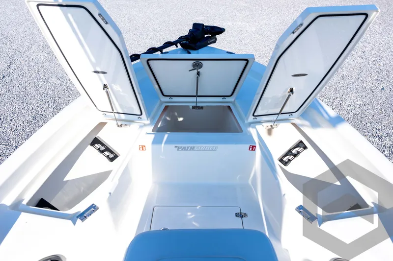Slide: The Image of 2026 Pathfinder 2200 TRS boat with open storage compartments on deck. - 39