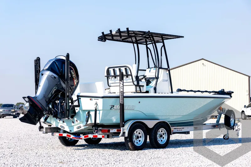 Slide: The Image of 2026 Pathfinder 2200 TRS boat on trailer, featuring sleek design and powerful outboard motor. - 5