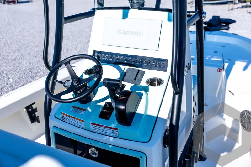 Slide: The Image of 2026 Pathfinder 2200 TRS boat console with Garmin navigation system and steering wheel. - 52