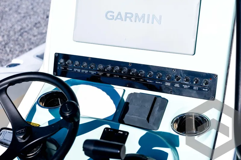 Slide: The Image of Control panel of 2026 Pathfinder 2200 TRS boat with Garmin display and switches. - 53