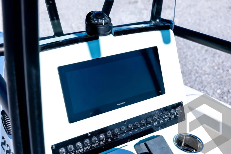 Slide: The Image of 2026 Pathfinder 2200 TRS boat dashboard with Garmin display and compass. - 55